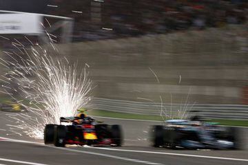 Sparks fly behind Max Verstappen in the Aston Martin Red Bull Racing RB14 TAG Heuer and Lewis Hamilton in the Mercedes AMG Petronas F1 Team Mercedes WO9 in Bahrain.