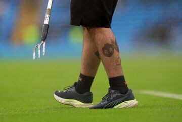 Soccer Football - Premier League - Manchester City v Fulham - Etihad Stadium, Manchester, Britain - November 5, 2022 General view of a Manchester United tattoo on the leg of groundsman inside the stadium before the match Action Images via Reuters/Lee Smith EDITORIAL USE ONLY. No use with unauthorized audio, video, data, fixture lists, club/league logos or 'live' services. Online in-match use limited to 75 images, no video emulation. No use in betting, games or single club /league/player publications.  Please contact your account representative for further details.