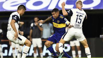 BUENOS AIRES, ARGENTINA - MARCH 07: Carlos Tevez of Boca Juniors fights for the ball with Maximiliano Caire and Paolo Goltz of Gimnasia during a match between Boca Juniors and Gimnasia as part of Superliga 2019/20 at Estadio Alberto J. Armando on March 7, 2020 in Buenos Aires, Argentina. (Photo by Rodrigo Valle/Getty Images)