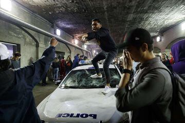 TORONTO, ON - JUNE 13: People stand on a Police cruiser as they celebrate a victory over the Golden State Warriors in game six of the NBA Finals on June 13, 2019 in Toronto, Canada.   