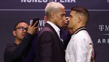 LAS VEGAS, NEVADA - DECEMBER 09: Charles Oliveira of Brazil and Dustin Poirier face off during the UFC 269 press conference at MGM Grand Garden Arena on December 09, 2021 in Las Vegas, Nevada.   Carmen Mandato/Getty Images/AFP == FOR NEWSPAPERS, INTERNET