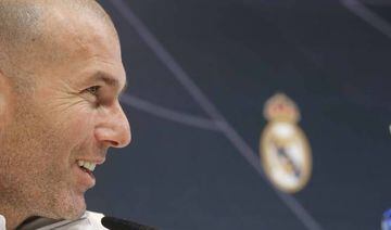 Zinedine Zidane with the Real Madrid crest behind him.