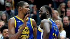 (FILES) In this file photo taken on October 19, 2018 Kevin Durant (L) of the Golden State Warriors tries to calm down teammate Draymond Green after a foul in the second half of a NBA game against the Utah Jazz in Salt Lake City, Utah. NOTE TO USER: User e