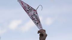 A protester holds a wire hanger while participating in a pro-abortion rights march and rally.