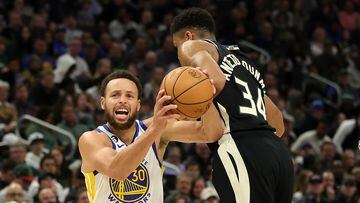 Stephen Curry #30 of the Golden State Warriors is fouled by Giannis Antetokounmpo #34 of the Milwaukee Bucks during the second half of a game at Fiserv Forum on December 13, 2022 in Milwaukee, Wisconsin.