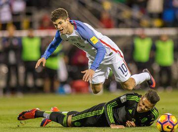 Nov 11, 2016; Columbus, OH, USA; USA midfielder Christian Pulisic (10) is fouled by Mexico defender Carlos Salcido (3) during the second half of the match at MAPFRE Stadium. Mexico beats the USA 2-1. Mandatory Credit: Trevor Ruszkowski-USA TODAY Sports