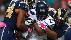ST. LOUIS, MO - OCTOBER 19: Marshawn Lynch #24 of the Seattle Seahawks is tackled by Aaron Donald #99 and Robert Quinn #94 of the St. Louis Rams int he third quarter at the Edward Jones Dome on October 19, 2014 in St. Louis, Missouri. The Rams beat the Seahawks 28-26.   Dilip Vishwanat/Getty Images/AFP == FOR NEWSPAPERS, INTERNET, TELCOS &amp; TELEVISION USE ONLY ==