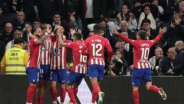 Atletico Madrid's Spanish midfielder #14 Marcos Llorente (2nd-R) celebrates with teammates after scoring his team's first goal during the Spanish league football match between Real Madrid CF and Club Atletico de Madrid at the Santiago Bernabeu stadium in Madrid on February 4, 2024. (Photo by Thomas COEX / AFP)