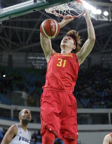 China's Wang Zhelin (31) scores over France's Tony Parker (9) during a men's basketball game at the 2016 Summer Olympics in Rio de Janeiro, Brazil, Monday, Aug. 8, 2016.