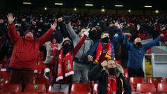 Liverpool supporters celebrate a goal during the English Premier League football match between Liverpool and Wolverhampton Wanderers at Anfield in Liverpool, north west England on December 6, 2020. (Photo by Clive Brunskill / POOL / AFP) / RESTRICTED TO E
