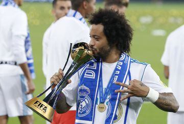 Real Madrid's Marcelo kisses the trophy after winning the Club World Cup final soccer match between Real Madrid and Gremio.