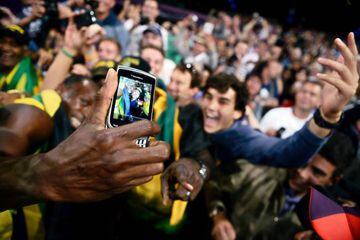 Bolt takes selfie with spectators as he celebrates Jamaica winning and setting a new world record in the men's 4X100 relay final at the London 2012 Olympic Games in 2012.