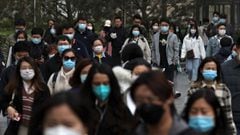 People walk on a street during morning rush hour, following the coronavirus disease (COVID-19) outbreak, in Beijing, China March 16, 2022. REUTERS/Tingshu Wang