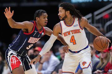 HOUSTON, TEXAS - DECEMBER 16: Derrick Rose #4 of the New York Knicks controls the ball against Josh Christopher #9 of the Houston Rockets during the first half at Toyota Center on December 16, 2021 in Houston, Texas.