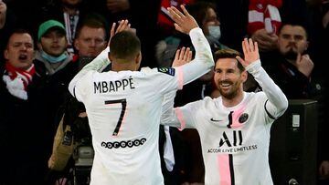 Lionel Messi is congratulated by Kylian Mbappe after scoring against Lille. 