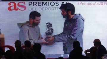 AS' Vicente Jimenez shown on the big screen handing Messi his award.