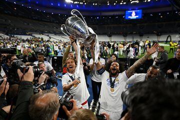 Luka Modric and Marcelo celebrate with the Champions League trophy after being Liverpool in Paris.