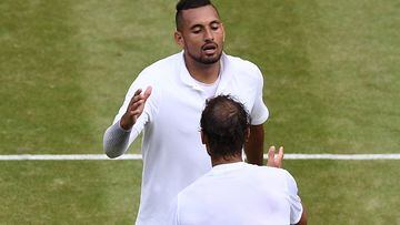 (FILES) In this file photo taken on July 4, 2019 Australia's Nick Kyrgios (top) shakes hands with Spain's Rafael Nadal (bottom) after Nadal won their men's singles second round match on the fourth day of the 2019 Wimbledon Championships at The All England Lawn Tennis Club in Wimbledon, southwest London. - Rafael Nadal and Nick Kyrgios will meet for a place in the Wimbledon final on July 8, 2022 in what the Australian star claims will be "the most watched tennis match ever." Nadal leads their series 6-3. AFP Sport looks at four of their most memorable matches in a rivalry which has been thrilling and often testy. (Photo by Daniel LEAL / AFP)