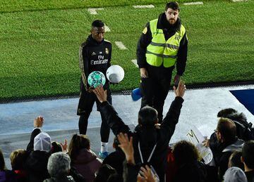 Real Madrid's Brazilian forward Vinicius Junior gives out balls to fans during a public training session at the Ciudad Real Madrid training ground in Valdebebas, Madrid, on December 30, 2019. (Photo by OSCAR DEL POZO / AFP)