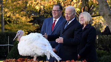 US President Joe Biden pardons the turkey &#039;Peanut Butter&#039; as Andrea Welp (R), turkey grower from Indiana, and Phil Seger, chairman of the National Turkey Federation, look on during the White House Thanksgiving turkey pardon.