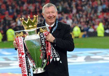 Manchester United's Scottish manager Alex Ferguson holds the Premier League trophy at the end of the English Premier League football match between Manchester United and Swansea City