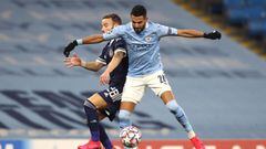 03 November 2020, England, Manchester: Manchester City&#039;s Riyad Mahrez (R) and Olympiacos&#039;s Mathieu Valbuena battle for the ball during the UEFA Champions League Group C soccer between Manchester City and Olympiacos at the Etihad Stadium. Photo: 