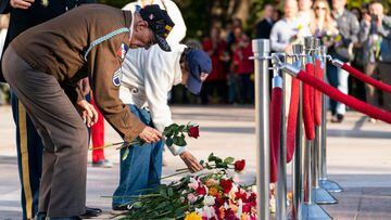 Darrell Bush, 96, left, a former US Army Staff Sgt., from Camp Springs, Maryland, and a WWII veteran of the Battle of the Bulge, places a flower with his wife Dorothy Bush, during a centennial commemoration event at the Tomb of the Unknown Soldier, in Arl