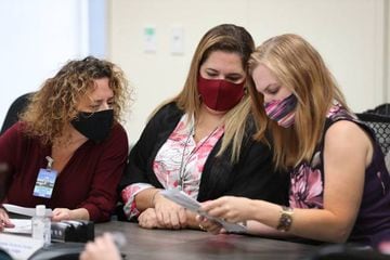 DORAL, FLORIDA - OCTOBER 15: (L-R) Milena Abreu, County Judge, Victoria Ferrer, County Judge, and Christina White, Supervisor of Elections, inspect Vote-by-Mail ballots for valid signatures.