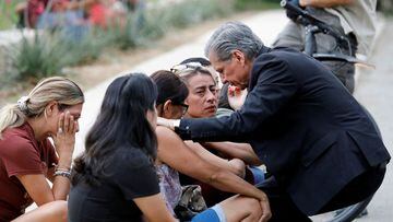 Gustavo Garcia-Siller, Archbishop of the Archdiocese of San Antonio, comforts people  outside the Ssgt Willie de Leon Civic Center, where students had been transported from Robb Elementary School after the shooting.