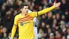 Barcelona's Polish forward #09 Robert Lewandowski gestures next to Valencia's Guinean defender #04 Mouctar Diakhaby during the Spanish league football match between Valencia CF and FC Barcelona at the Mestalla stadium in Valencia on December 16, 2023. (Photo by JOSE JORDAN / AFP)