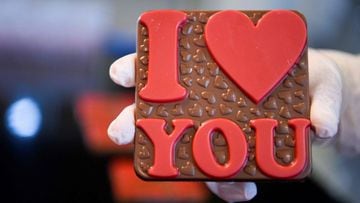 A worker holds a freshly made chocolate at the &quot;Amel&quot; handcrafted chocolate factory near Pristina on February 12, 2022, ahead of Valentine&#039;s Day -  with chocolate one of the most popular gifts each February 14. (Photo by Armend NIMANI / AFP