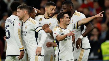Real Madrid's Spanish forward #21 Brahim Diaz celebrates with teammates after scoring his team's first goal during the Spanish league football match between Real Madrid CF and Granada FC at the Santiago Bernabeu stadium in Madrid on December 1, 2023. (Photo by OSCAR DEL POZO / AFP)