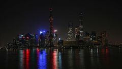 In this long exposure photograph, Pudong district is pictured during a lockdown imposed as a preventive measure against the spread of the Covid-19 coronavirus, in Shanghai on March 28, 2022. - Millions of people in China&#039;s financial hub were confined