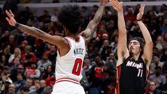 Nov 20, 2023; Chicago, Illinois, USA; Miami Heat guard Jaime Jaquez Jr. (11) shoots against Chicago Bulls guard Coby White (0) during the second half at United Center. Mandatory Credit: Kamil Krzaczynski-USA TODAY Sports