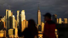 People look at the New York City skyline of Manhattan in New York City. 