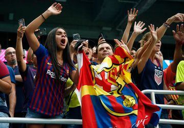 Fans try to get the attention of players during the International Champions Cup football match between FC Barcelona and SSC Napoli at Hard Rock Stadium in Miami, Florida, on August 7, 2019. (Photo by RHONA WISE / AFP)