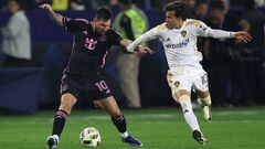 CARSON, CALIFORNIA - FEBRUARY 25: Lionel Messi #10 of Inter Miami dribbles past the defense of Riqui Puig #10 of Los Angeles Galaxy during the first half of a game at Dignity Health Sports Park on February 25, 2024 in Carson, California.   Sean M. Haffey/Getty Images/AFP (Photo by Sean M. Haffey / GETTY IMAGES NORTH AMERICA / Getty Images via AFP)