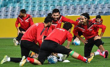 Syria's player Tamer Hag Mohd shares a light moment with teammates during their training session in Sydney.