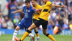 LONDON, ENGLAND - MAY 07: Christian Pulisic of Chelsea is challenged by Rayan Ait-Nouri and Romain Saiss of Wolverhampton Wanderers  during the Premier League match between Chelsea and Wolverhampton Wanderers at Stamford Bridge on May 07, 2022 in London, England. (Photo by Catherine Ivill/Getty Images)