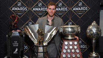 Edmonton Oilers center Connor McDavid poses with the (left to right) Ted Lindsay Award