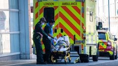 LONDON, ENGLAND - APRIL 19: Ambulance paramedics wearing personal protective equipment help a patient from an ambulance into The Royal London Hospital on April 19, 2020 in London, United Kingdom. In a press conference on Thursday, First Secretary of State