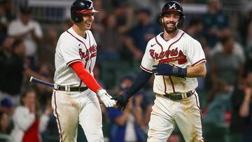 Atlanta Braves shortstop Dansby Swanson (7) celebrates after scoring with first baseman Matt Olson (28) against the Philadelphia Phillies in the fifth inning at Truist Park.