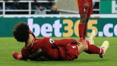 Liverpool&#039;s Egyptian midfielder Mohamed Salah falls to the ground after injuring himself in a challenge with Newcastle United&#039;s Slovakian goalkeeper Martin Dubravka (not pictured) during the English Premier League football match between Newcastl