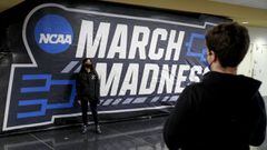Joey powers (right) and Kathleen Martinus take pictures in front of a March Madness sign during the first round of the 2021 NCAA Tournament on Thursday, March 18, 2021, at Mackey Arena in West Lafayette, Ind.   Mandatory Credit: Robert Scheer/IndyStar via