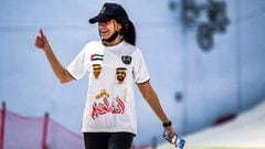 EDITORS NOTE: Graphic content / A participant wearing a shirt bearing the images of Abu Dhabi Crown Prince Sheikh Mohammed bin Zayed al-Nahyan (L) and Dubai&#039;s Emir Sheikh Mohammed bin Rashid al-Maktoum (R), and around her neck a mask due to the COVID