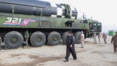 North Korean leader Kim Jong-un walks next to what state media reports is the "Hwasong-17" intercontinental ballistic missile (ICBM) on its launch vehicle in this undated photo released on March 25, 2022 by North Korea's Korean Central News Agency (KCNA).