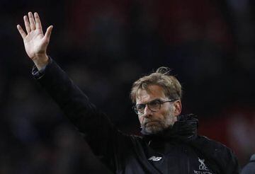Liverpool manager Juergen Klopp waves to fans after the game