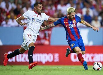 Lionel Messi holds of Sevilla's Gabriel Mercado.