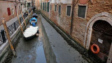 Boats are pictured in a canal during a severe low tide in the lagoon city of Venice, Italy, February 17, 2023. REUTERS/Manuel Silvestri REFILE - CORRECTING YEAR