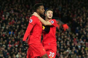 Liverpool's Belgian striker Divock Origi celebrates with Adam Lallana after securing a fourth goal in consecutive games.